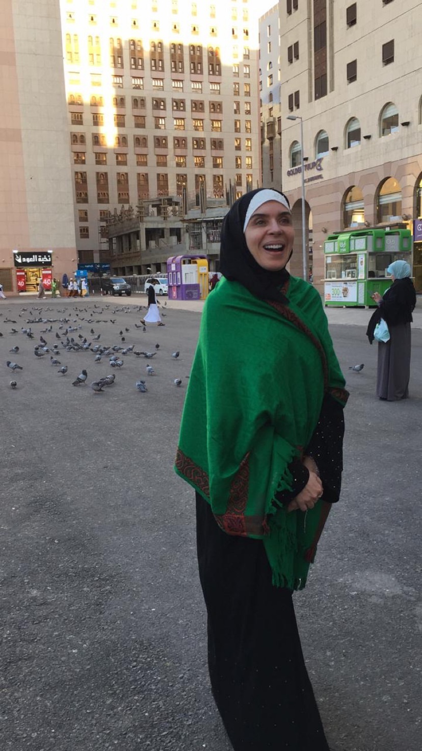 الفنانة دينا ترتدى شال أخضر خلال تواجدها فى مكة لأداء العمرة